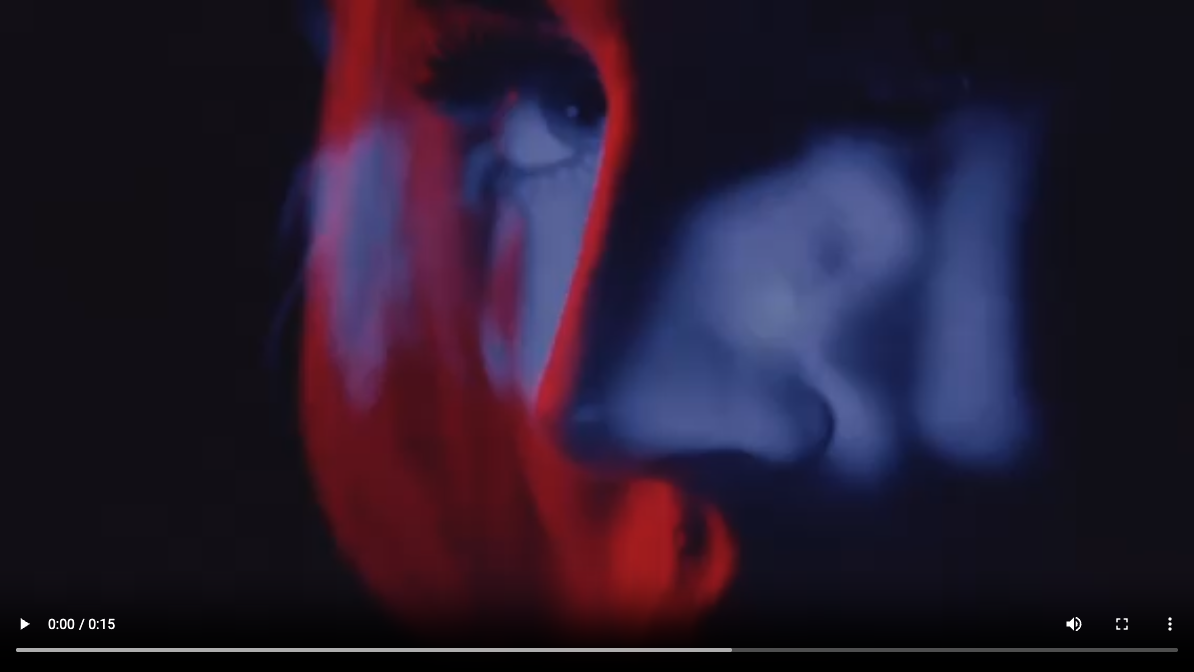 A close-up, abstract image of a persons face is shown in dramatic blue and red lighting. The persons eye and part of their face are visible, with blurred and painterly effects creating a moody, artistic feel.